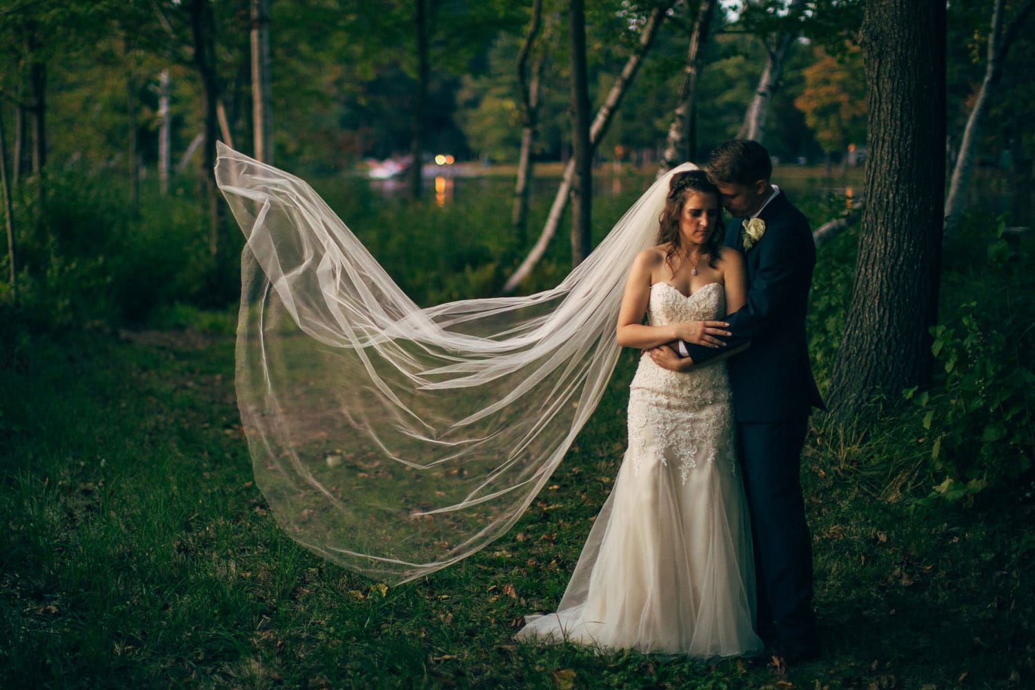 couple hugging with veil flowing in wind